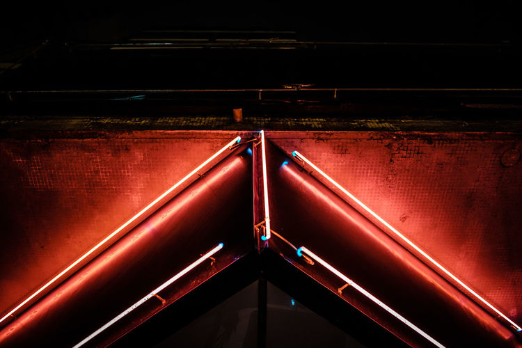 Low angle view of illuminated red railing