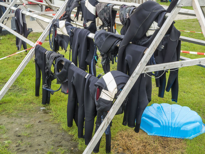 Wooden drying frame with wetsuits in a kitesurfing school on the german north sea coast in october.