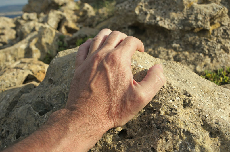 Close-up of man holding rock