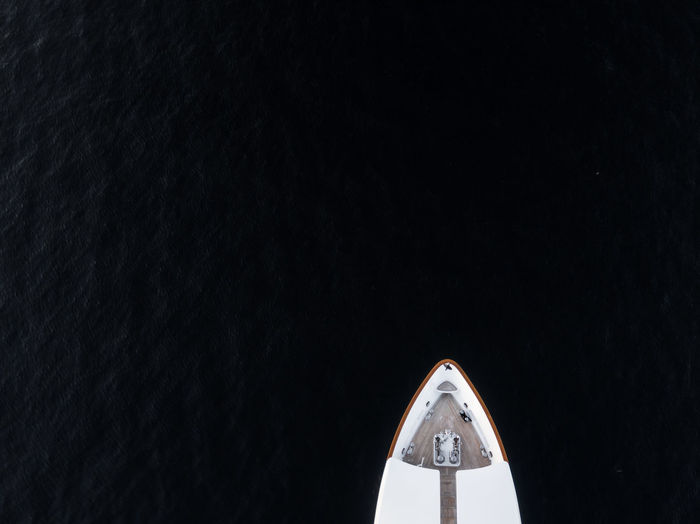 Aerial bird's eye partial view of the bow of a long white luxury yacht in sydney, australia