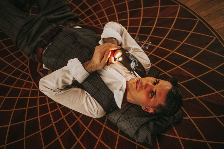High angle view of man lying on floor