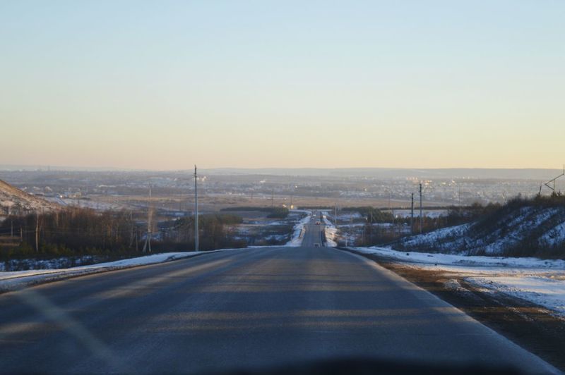 Road in winter against sky