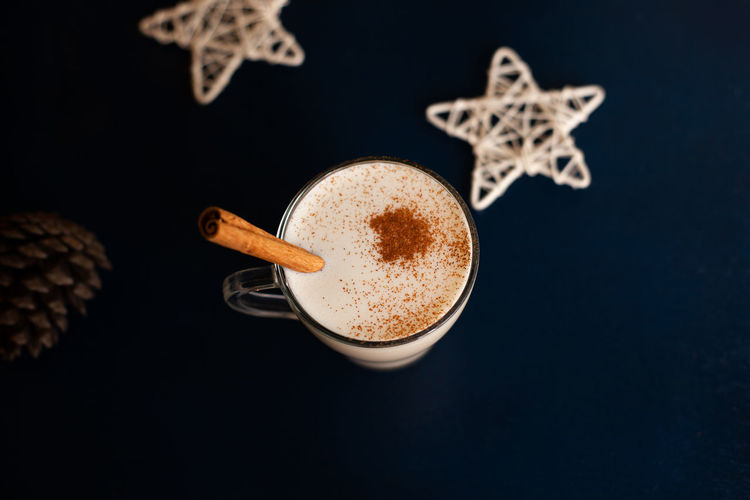 Homemade traditional christmas drink eggnog with spices and cinnamon. winter holidays