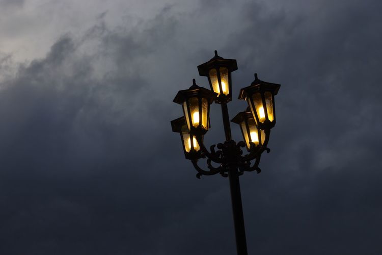Low angle view of illuminated street light against sky at night