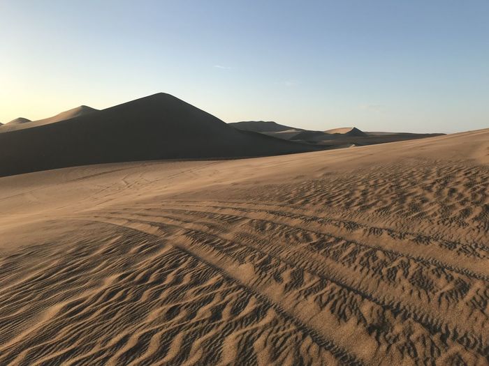 Scenic view of peruvian desert against clear sky, right before sunset.