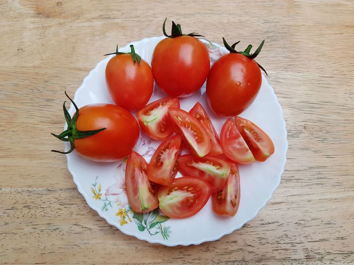 High angle view of tomatoes in plate on table