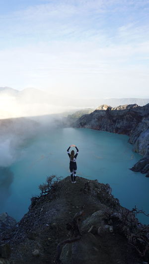 The beauty of the beautiful blue lake of ijen crater with mountain panorama