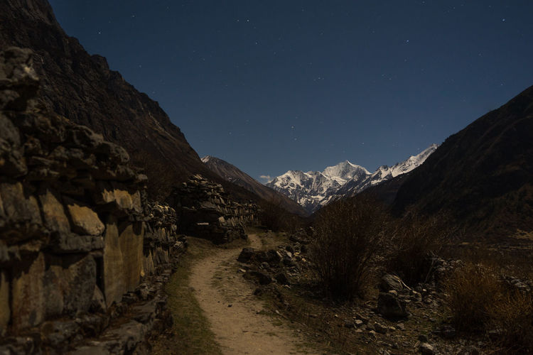 Scenic view of mountains against sky at night