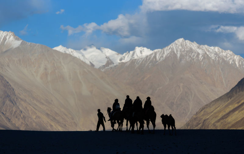 View of people riding horse on mountain