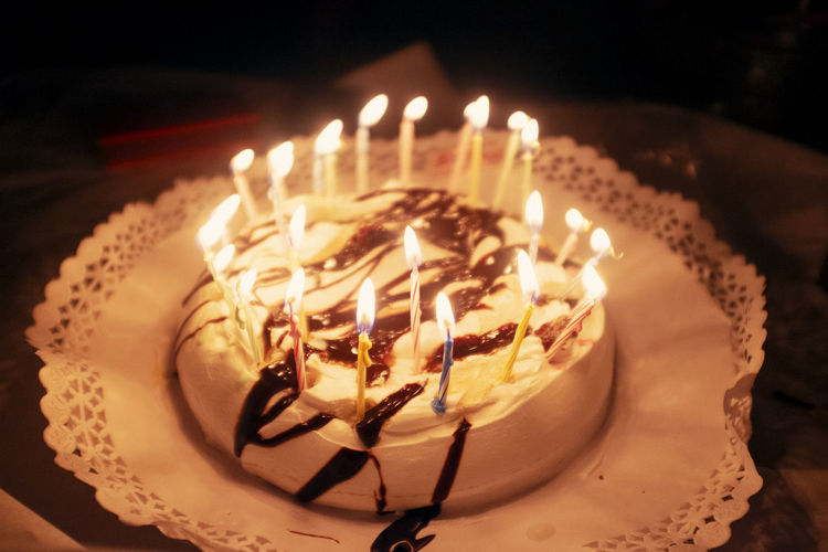 Close-up of cake with burning candles