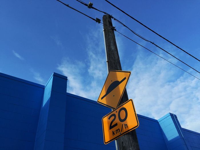 Low angle view of cables against blue sky