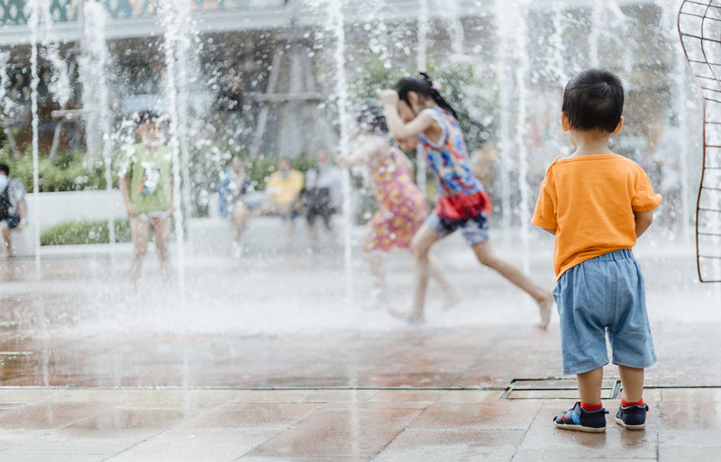 Kids playing public fountain