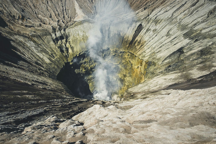 High angle view of smoke emitting from volcanic crater