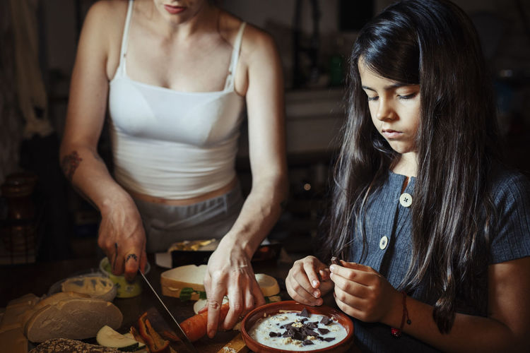 Young woman preparing food at table