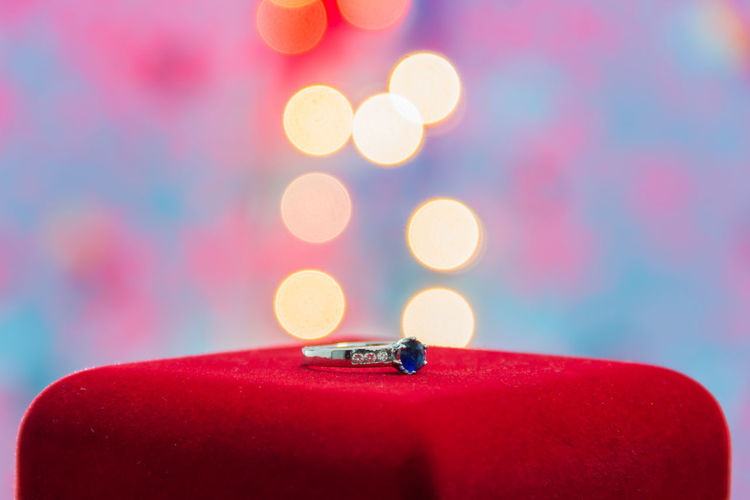 Close-up of wedding ring against illuminated lighting