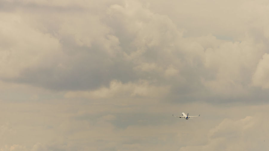 Low angle view of airplane flying in sky