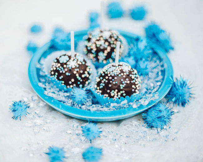 Assorted chocolates confectionery in a blue bowl. dark chocolate sweetness for dessert. party treats