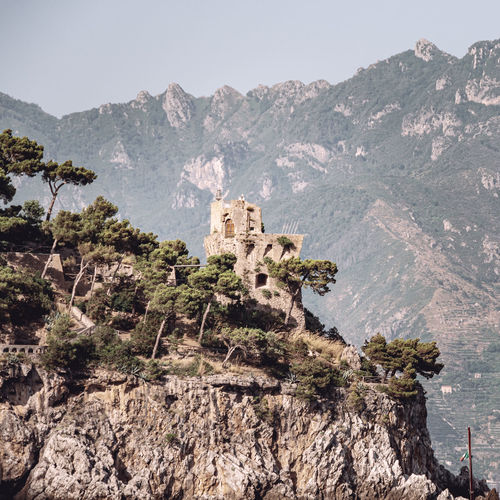 Coastal tower on the amalfi coast with the lattari mountains behind it