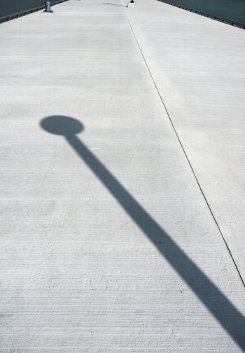 Shadow of person on footpath in park