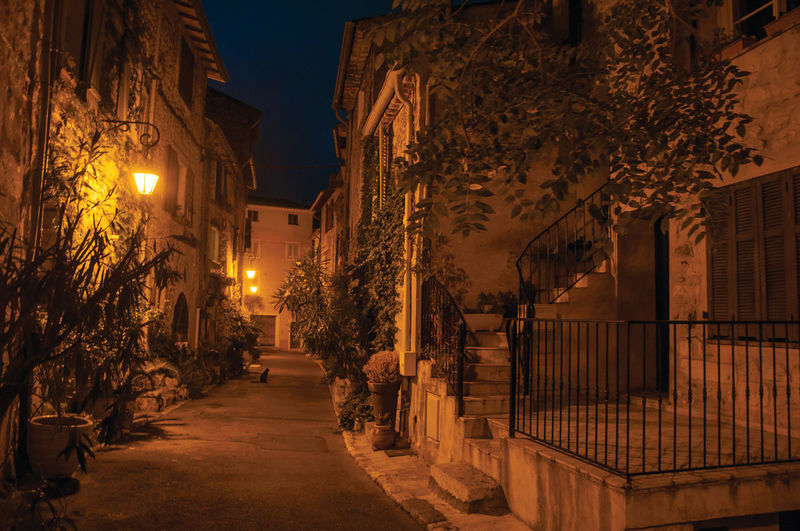 Night view of alley with walls and stone houses in the village of vence, in the french provence.