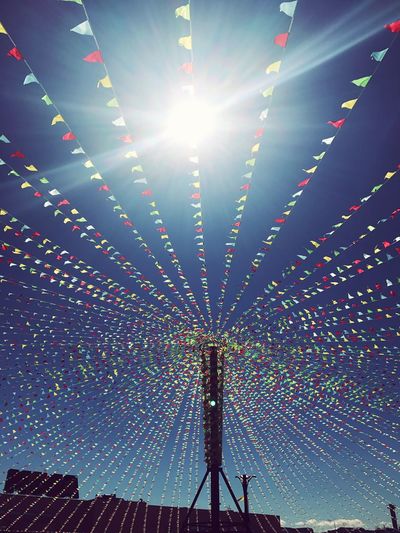 Illuminated ferris wheel against sky