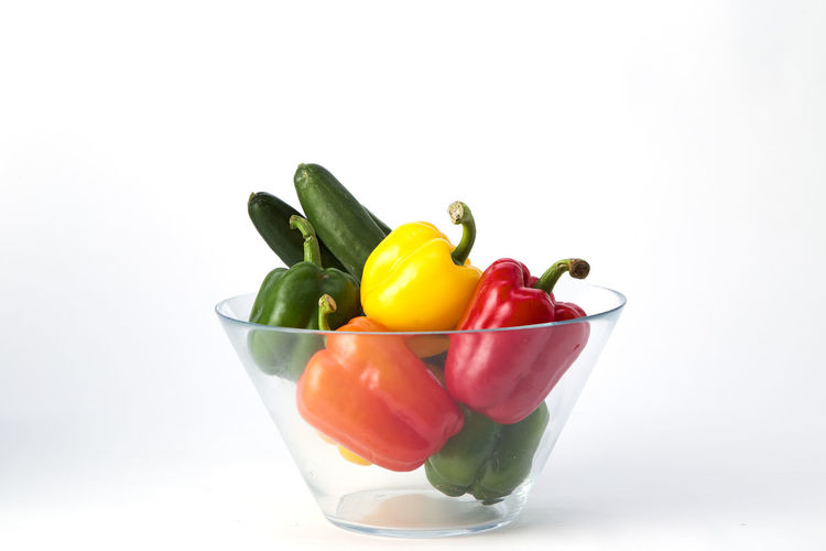 Close-up of peppers in bowl against white background