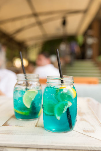 Close-up of drinks in jars on table