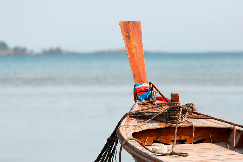 Traditional thailand wooden long tail boat in a tropical bay, andaman sea on background, copy space.