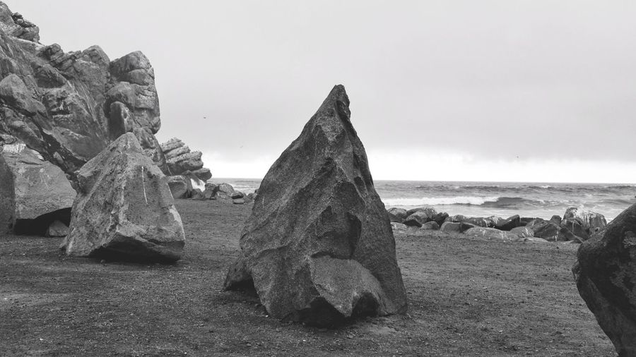 View of rocks on beach against sky