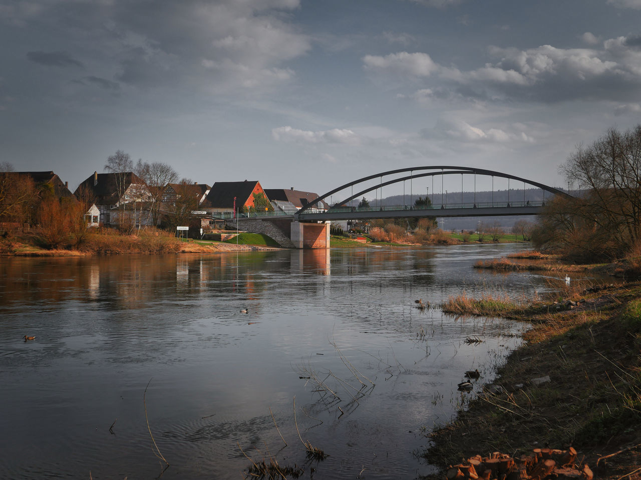 VIEW OF BRIDGE OVER RIVER AGAINST CLOUDY SKY