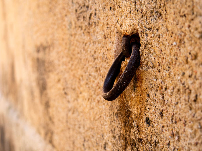 Close-up of rusty chain on wall