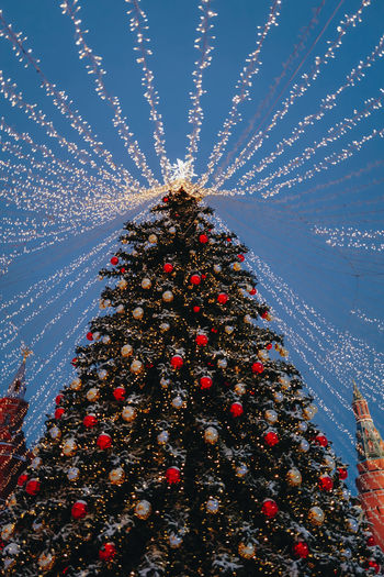Illuminated christmas tree against sky