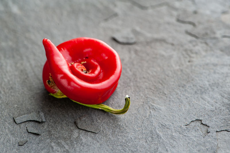 High angle view of red chili peppers on stone plate