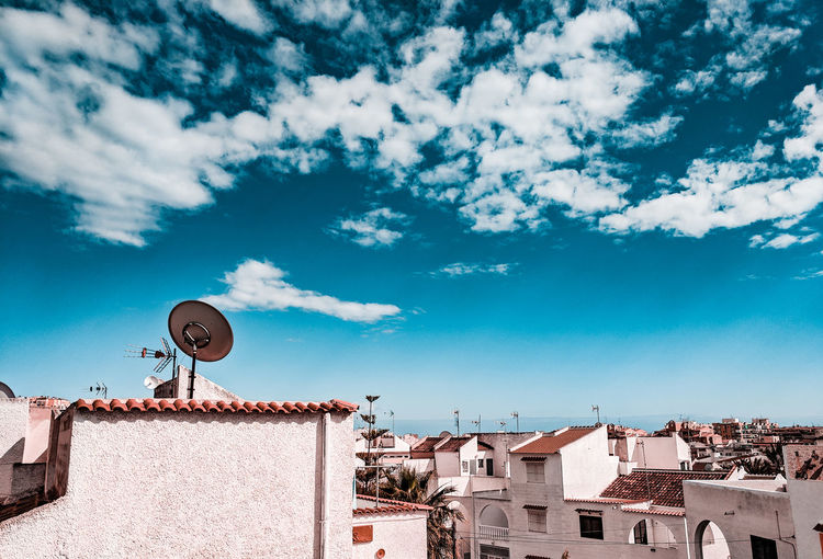 Low angle view of buildings against blue sky