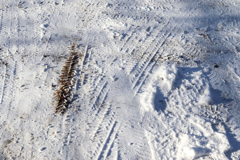 Tire tracks on snow covered streets in a close up view