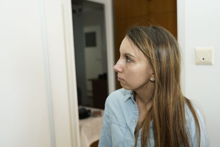 Woman looking away at home