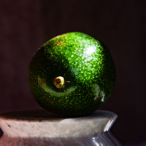 Close-up of green fruit on table