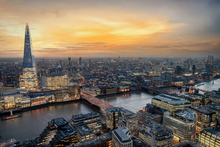 View of shard london bridge and cityscape during sunset