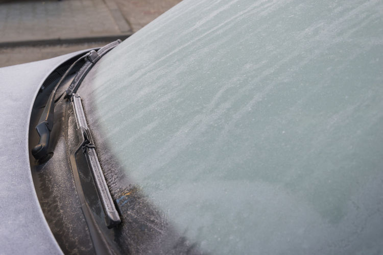 High angle view of car with frozen window 