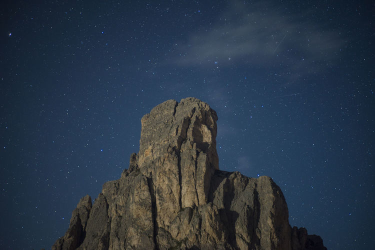 Low angle view of rock formations against sky at night