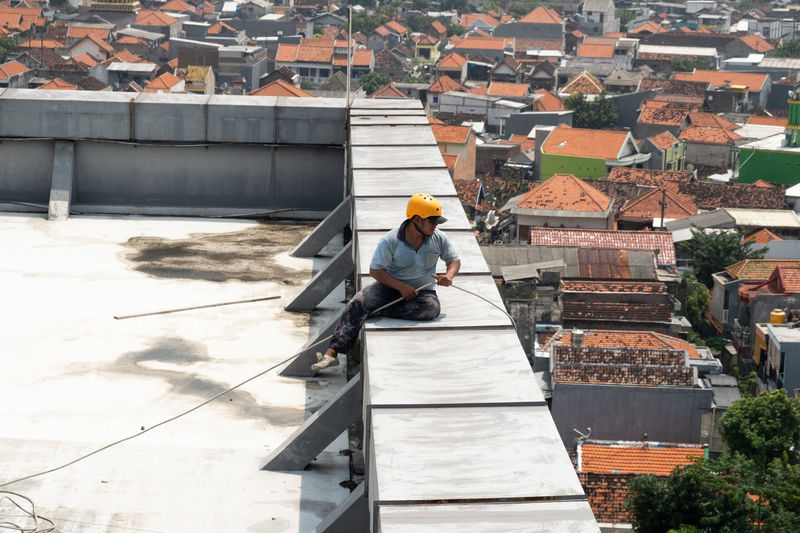 High angle view of man working at construction site in city