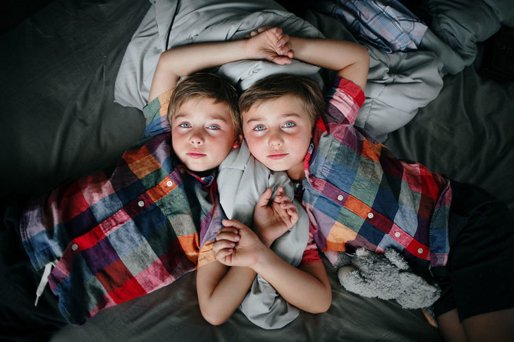 Portrait of boys on bed