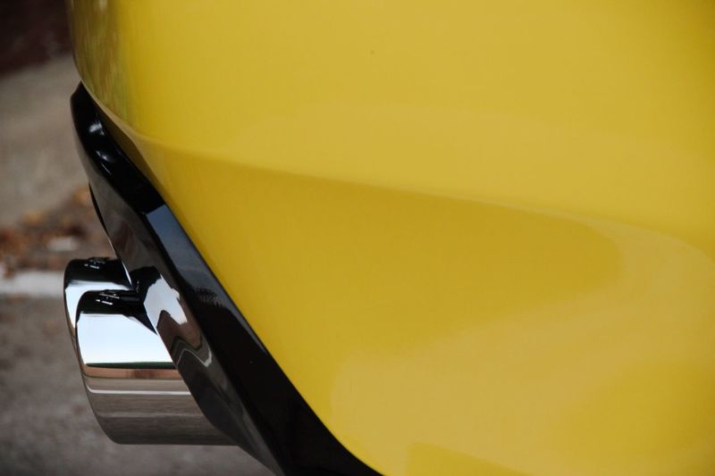 Close-up of yellow car exhaust pipe