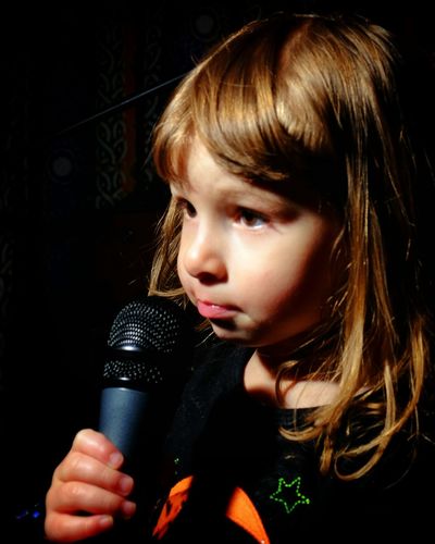 Close-up cute girl holding microphone