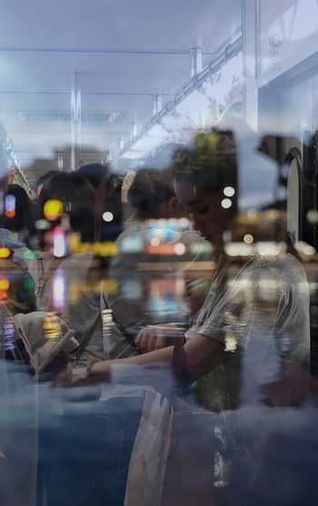 Digital composite image of people in train