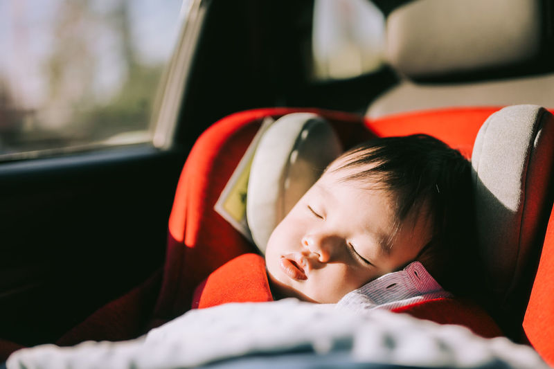 Cute boy sleeping in car