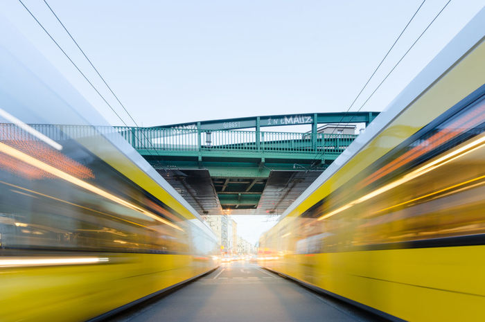 Blurred motion of yellow trains at railroad station