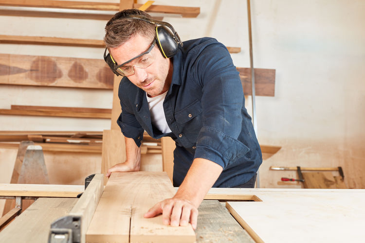 Smiling carpenter working at workshop