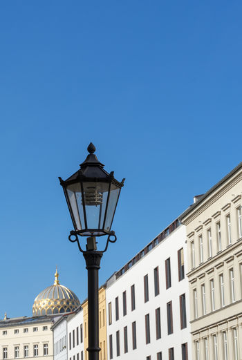 Low angle view of street light against building