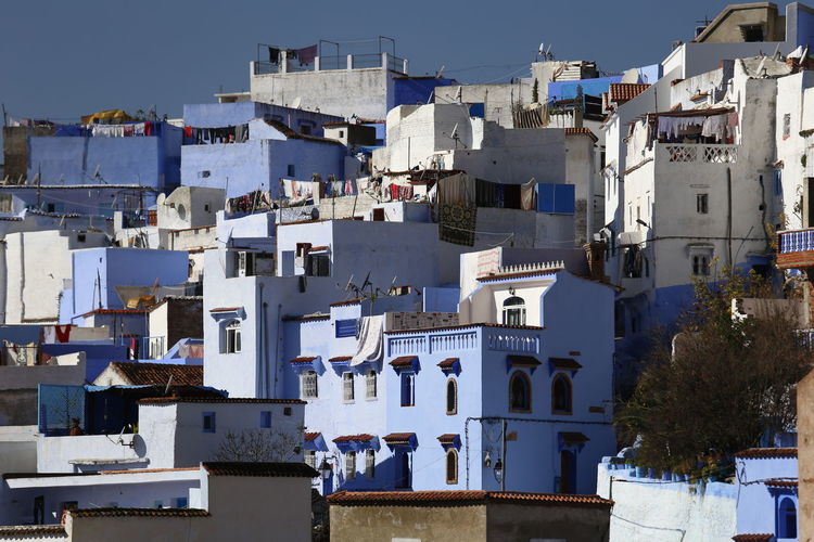 Residential buildings against blue sky, chefchaouen morocco 